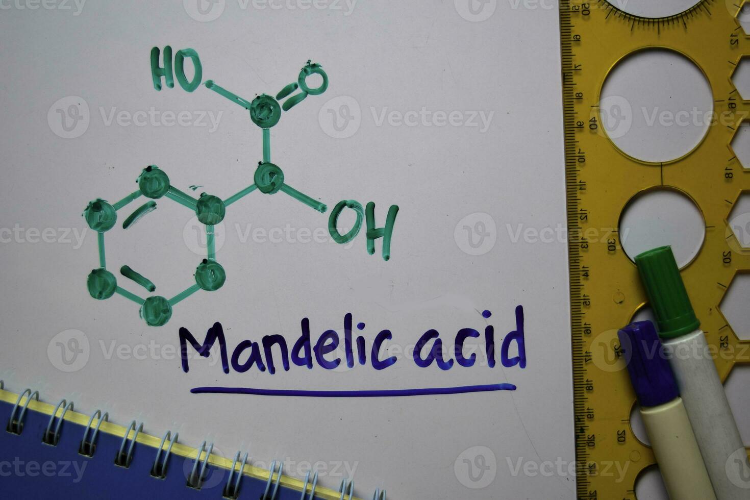 Mandelic Acid. Aromatic hydroxy acid molecule write on the white board. Structural chemical formula. Education concept photo