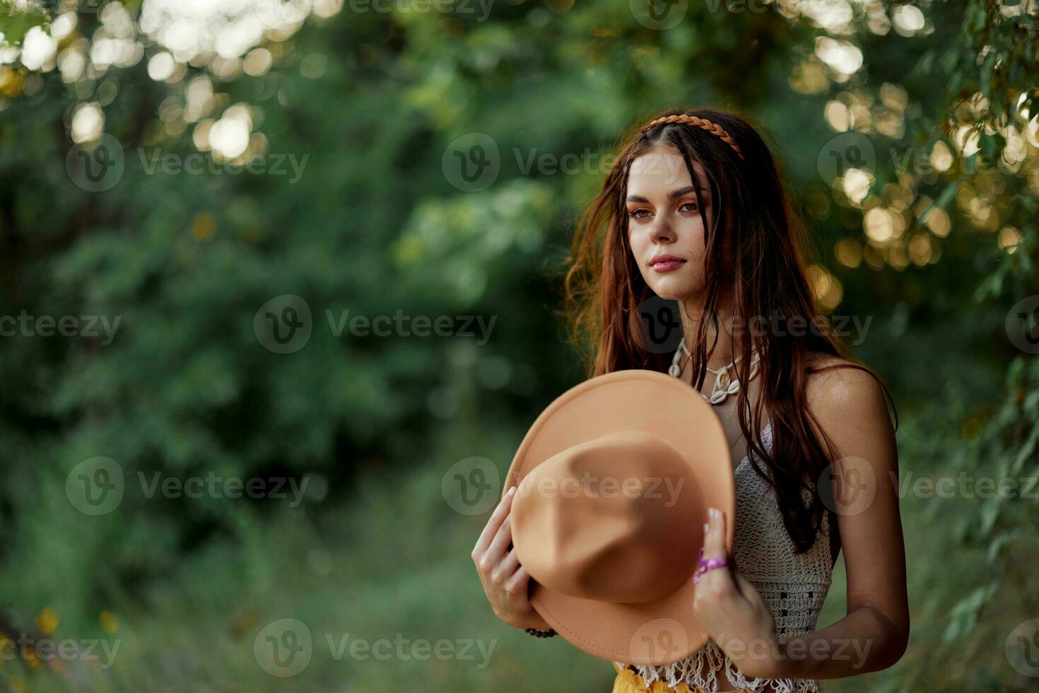 A woman dressed as a hippie with pigtails on her head travels outdoors at a campground in the fall and enjoys life photo