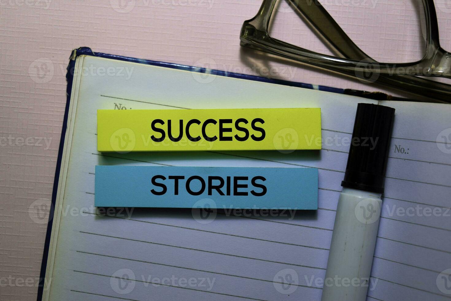Success Stories text on sticky notes isolated on office desk photo