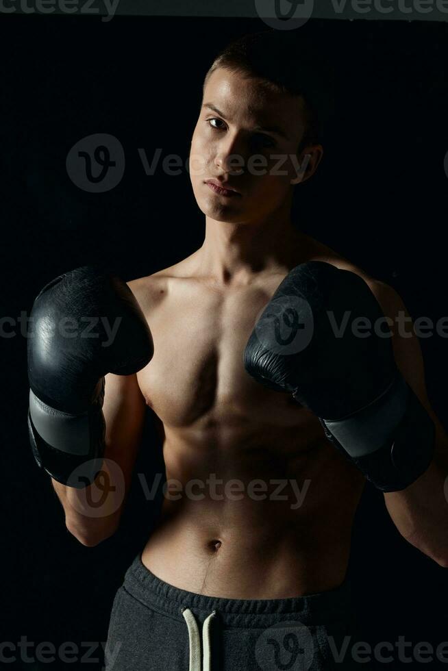 athlete boxing gloves on a black background nude torso boxing workout photo
