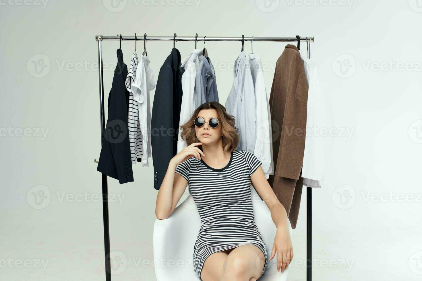 beautiful woman near the wardrobe shopaholic isolated background photo