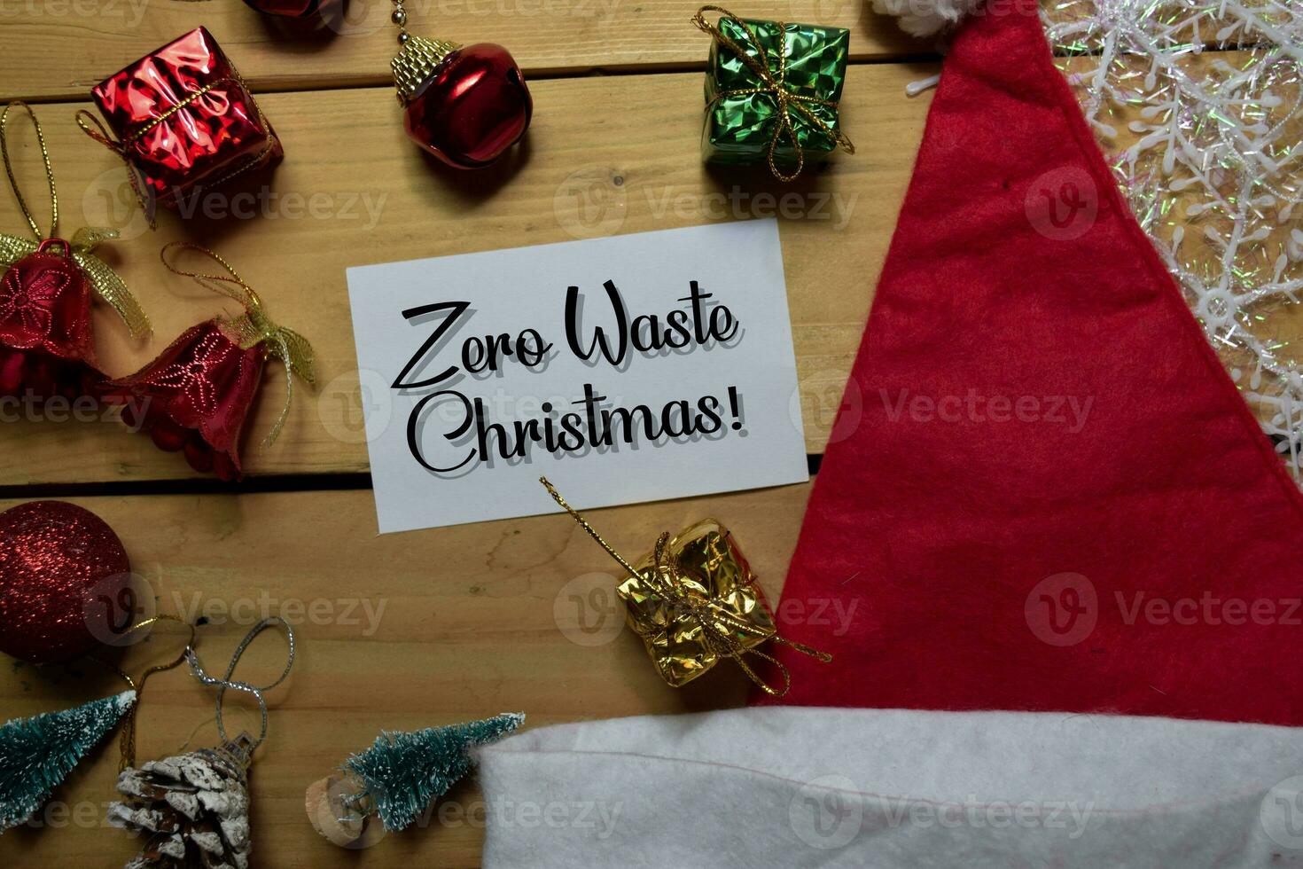 Zero Waste Christmas write on white paper with wooden backgroud. Frame of Christmas Decoration. photo