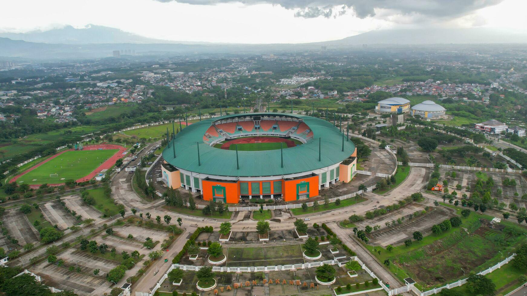 Aerial View of The largest stadium of Pakansari Bogor from drone and noise cloud. Bogor, Indonesia, March 3, 2022 photo