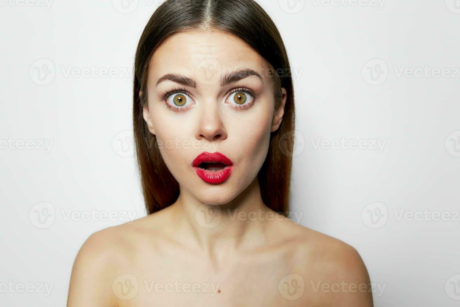 Surprised woman with red lips open mouth nude shoulders photo