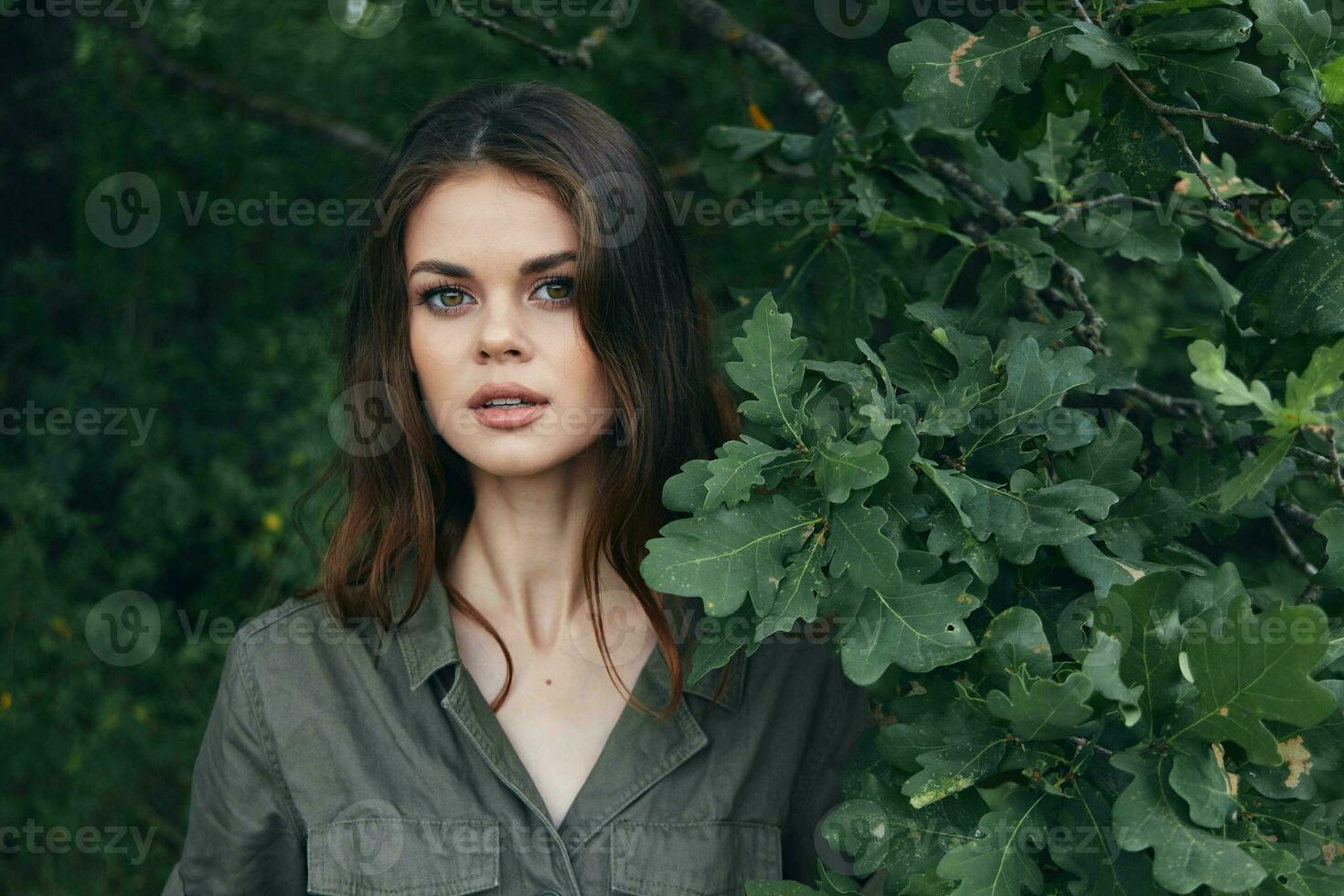 woman in the forest Attractive look green suit bush trees photo