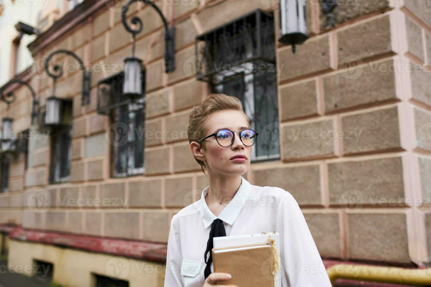 pretty woman on the street near the building rest education photo