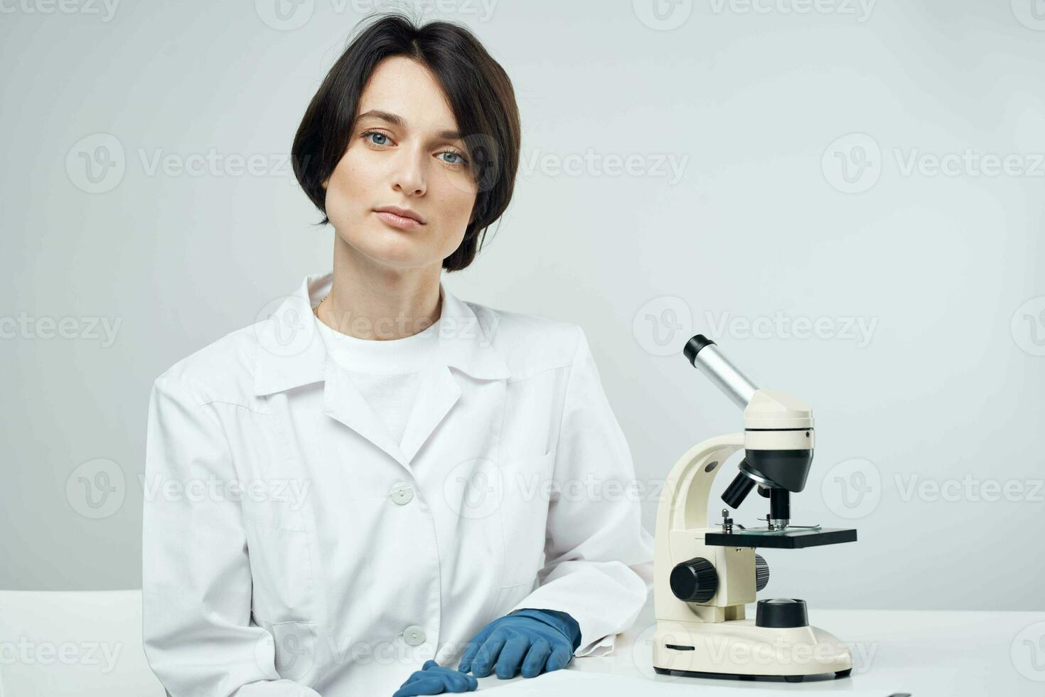 female scientist in white coat laboratory microscope science experiment photo