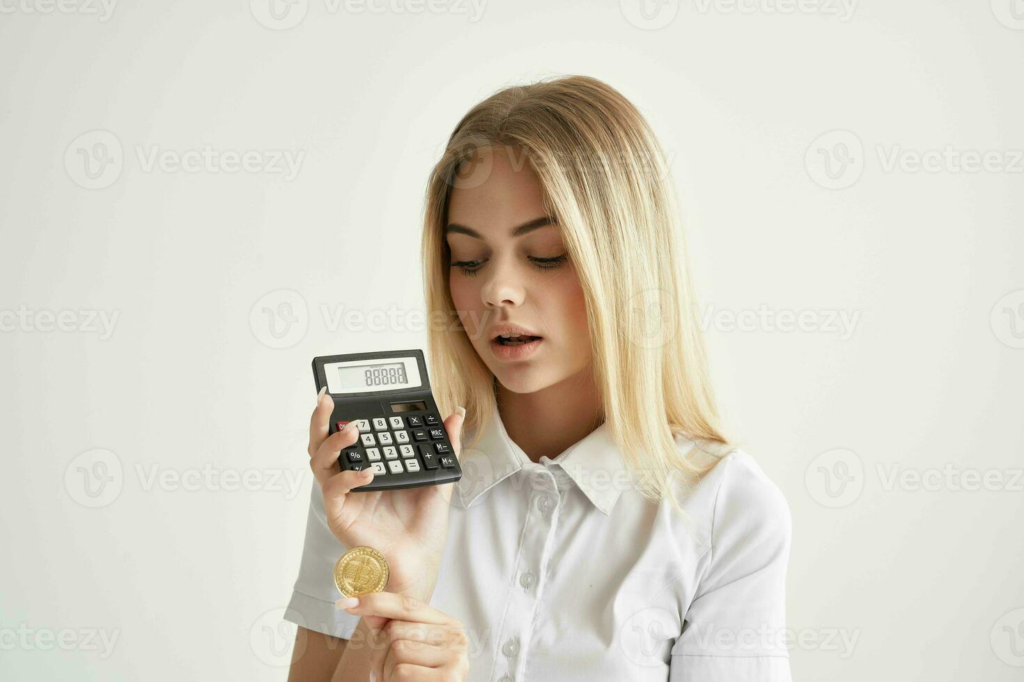 cheerful woman calculator in hand and bitcoin mining technologies photo