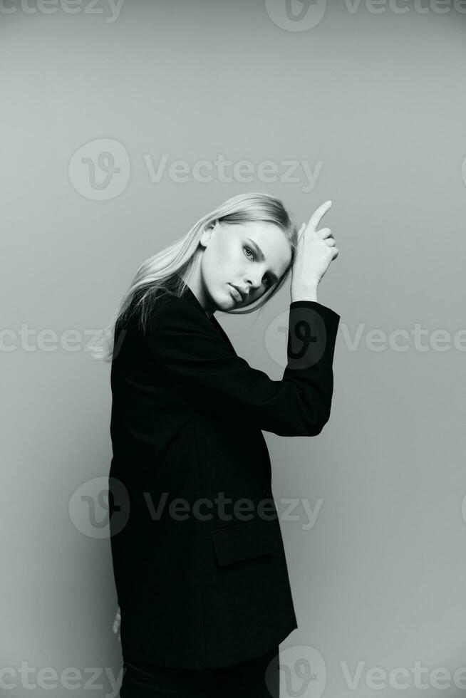Charming young professional model puts her hand to her face cheek in the studio. The concept for the new collection. Classic black and white photo