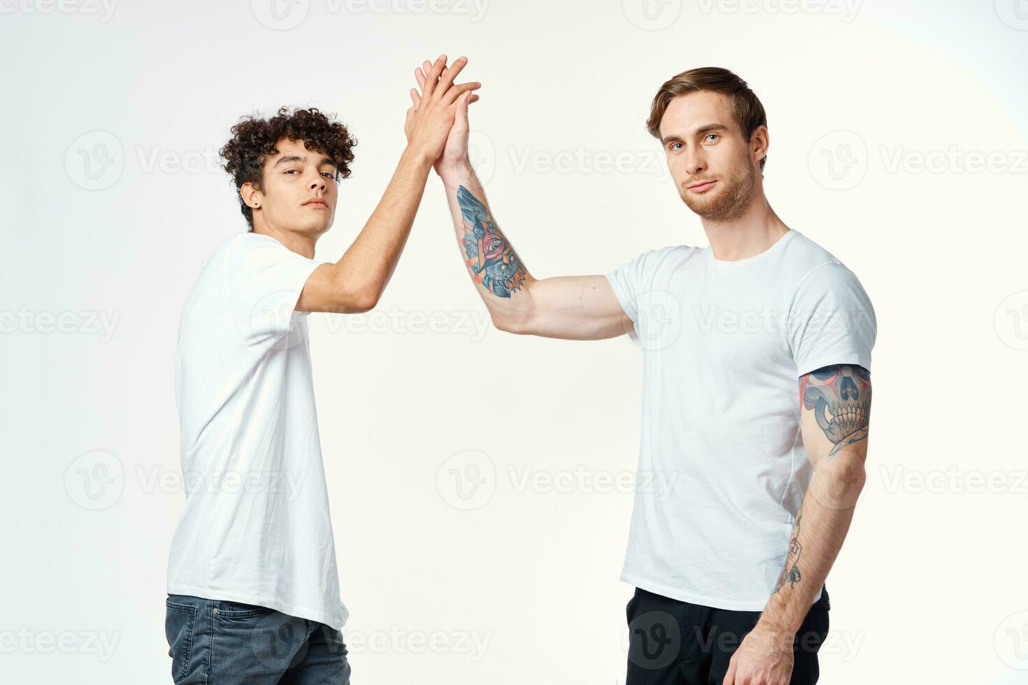 two friends in t-shirts holding hands emotions positive joy photo