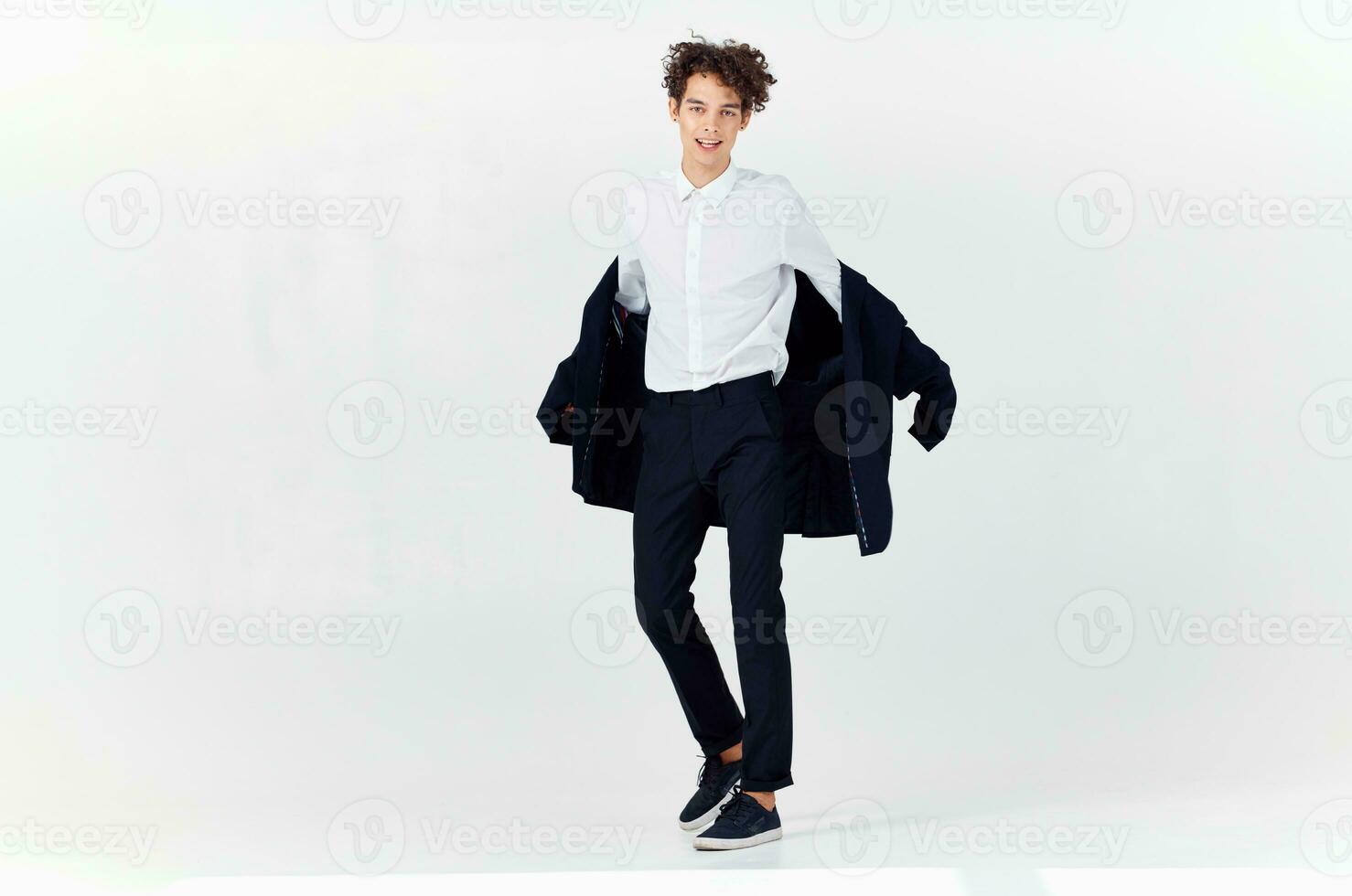 man curly hair suit modern style fashion posing photo