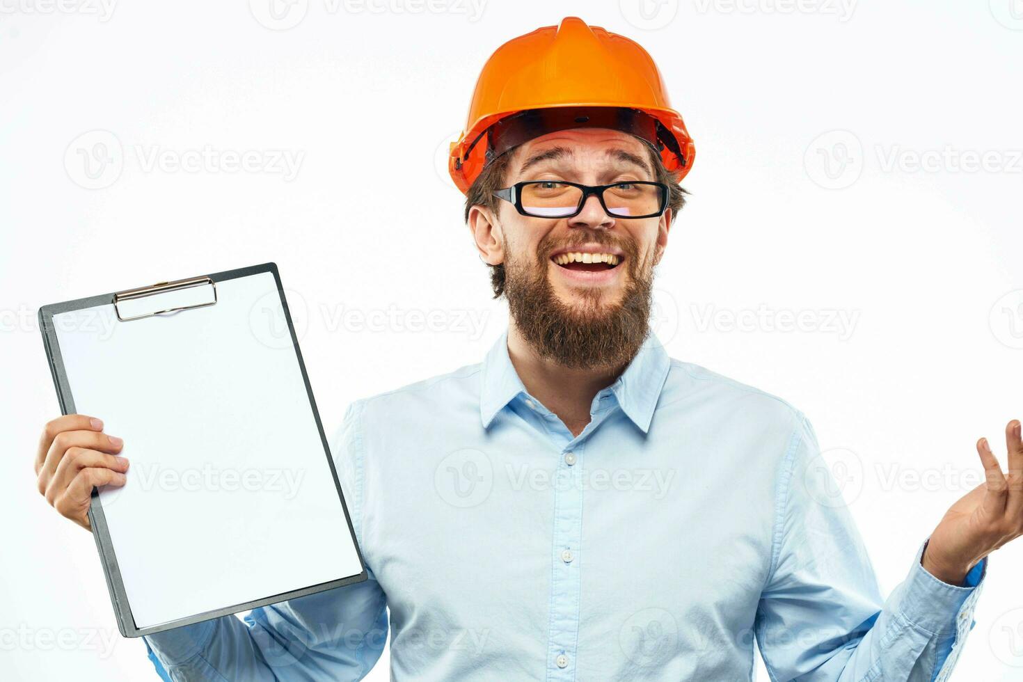 Cheerful workers orange paint documents construction industry light background photo