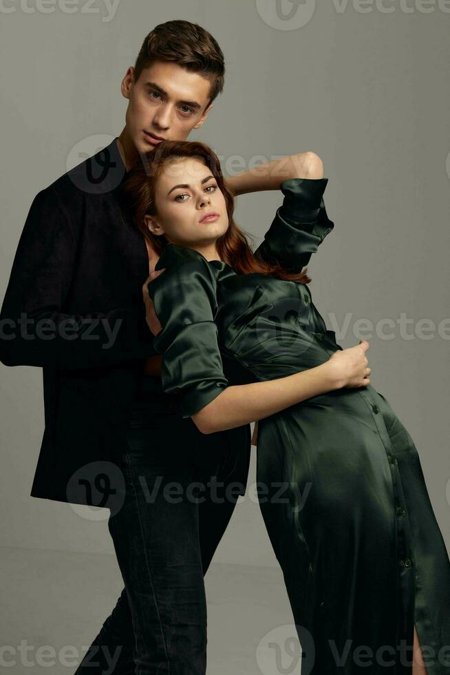 Enamored man and woman hug each other on a gray background Copy Space photo