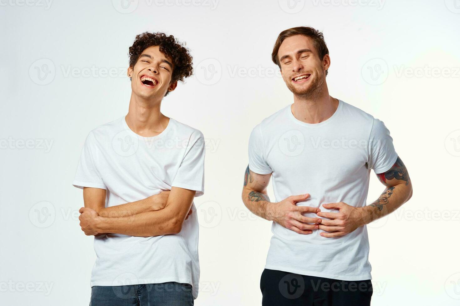 two funny friends in white t-shirts laughing positive emotions photo