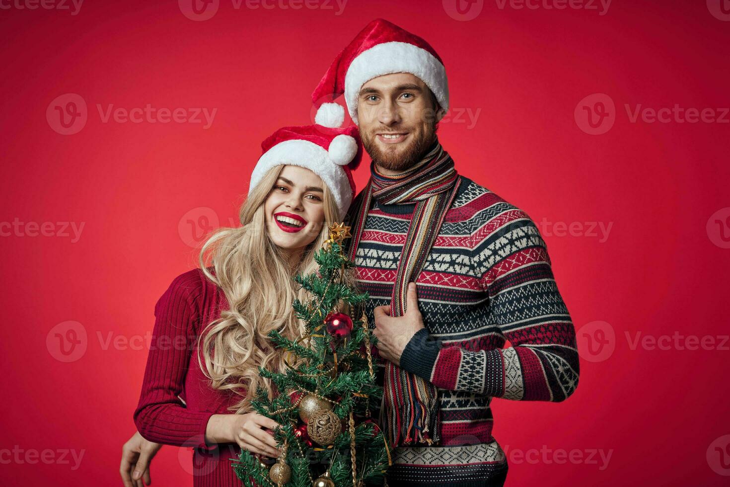 man and woman celebrate christmas happiness romance red background photo