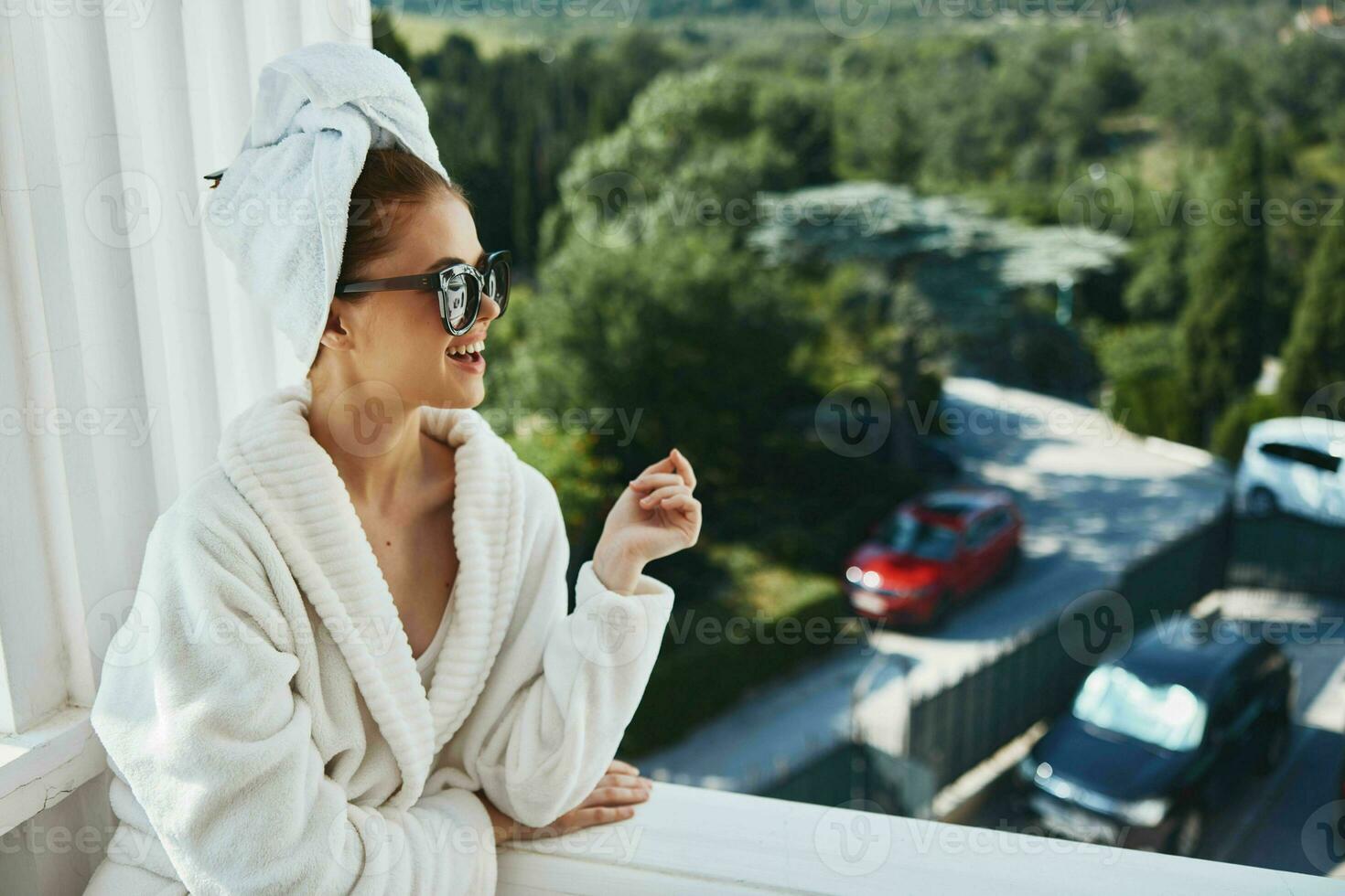 Attractive young woman in sunglasses at the hotel on the balcony Relaxation concept photo