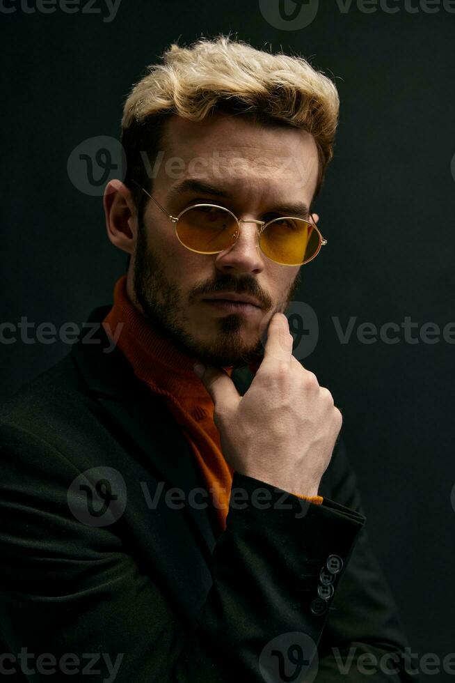 handsome blond guy in fashionable clothes on a black background portrait close-up photo