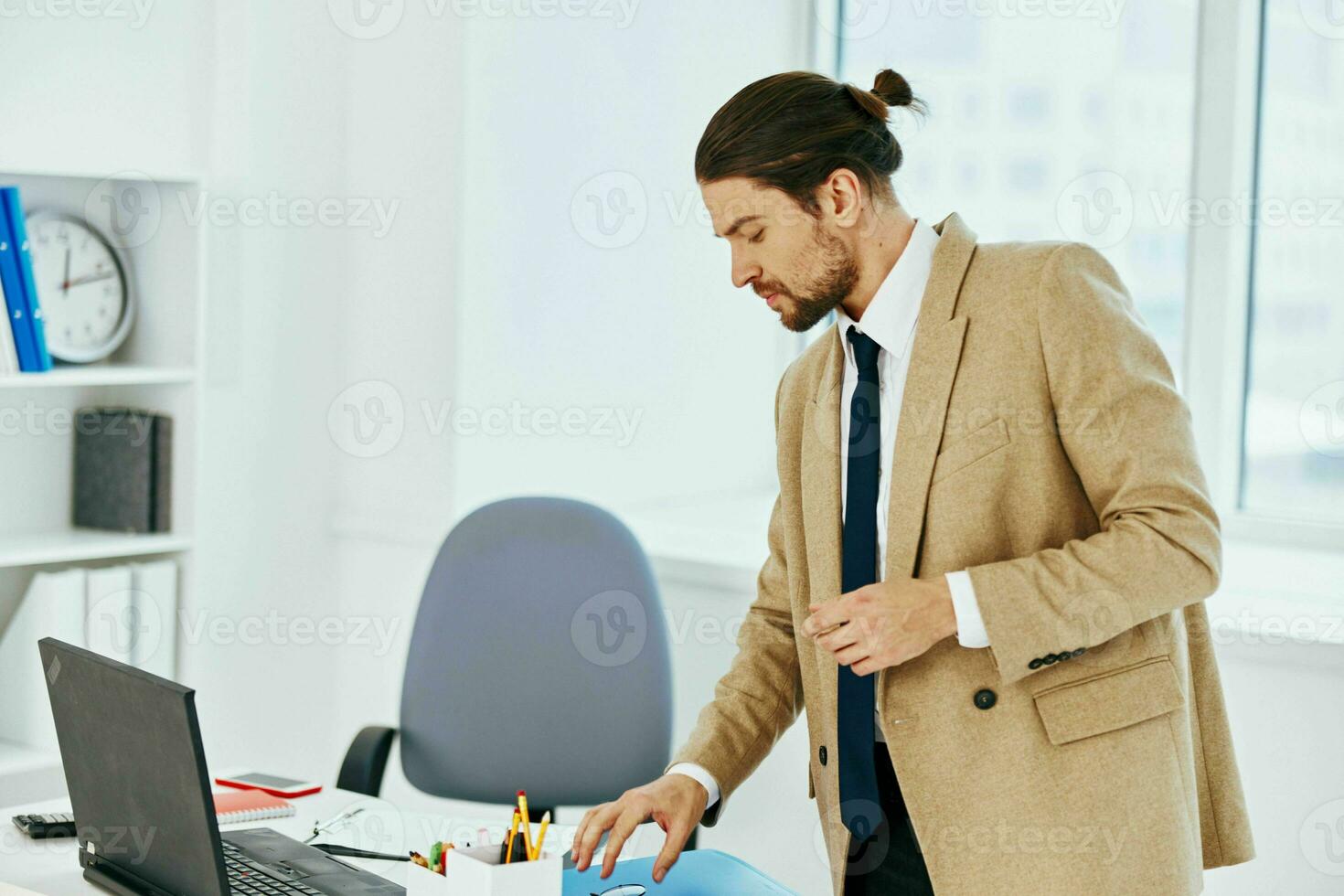 man in beige jacket holding a phone telephone office lifestyle photo