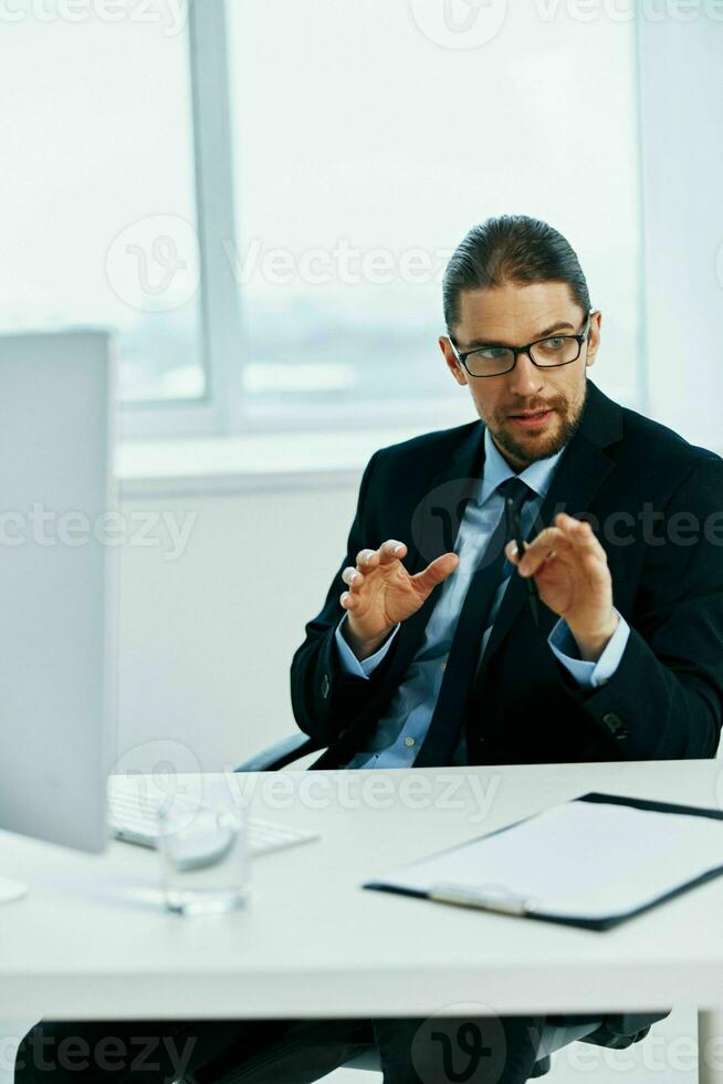 The man in a suit in the office gestures with his hands Lifestyle photo
