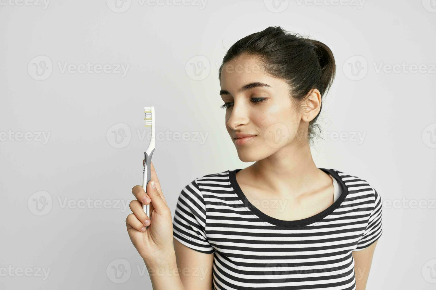 woman hygiene teeth cleaning care health light background photo