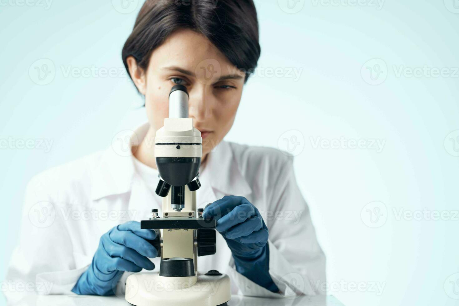 Woman in white coat laboratory science microscope analyzes photo