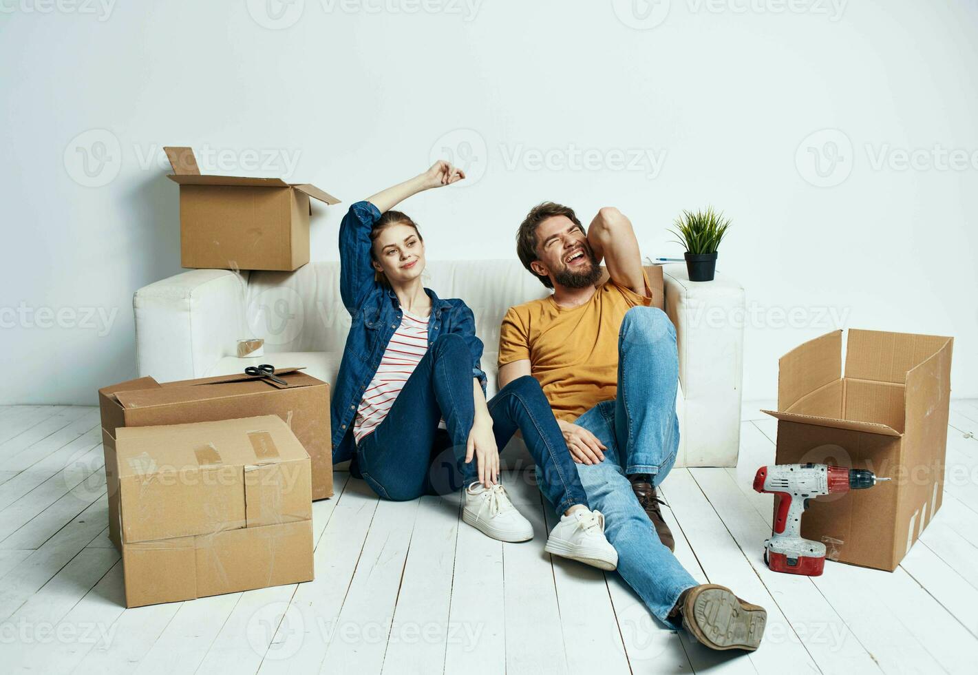 Men and women in a new apartment moving repair work boxes stuff photo