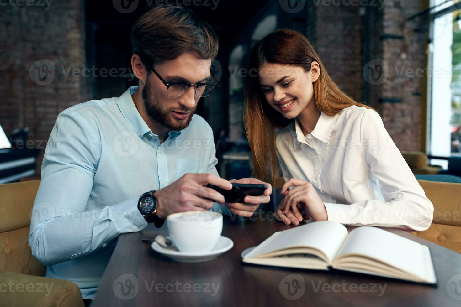 business man and woman sitting at the table communication work colleagues technology photo