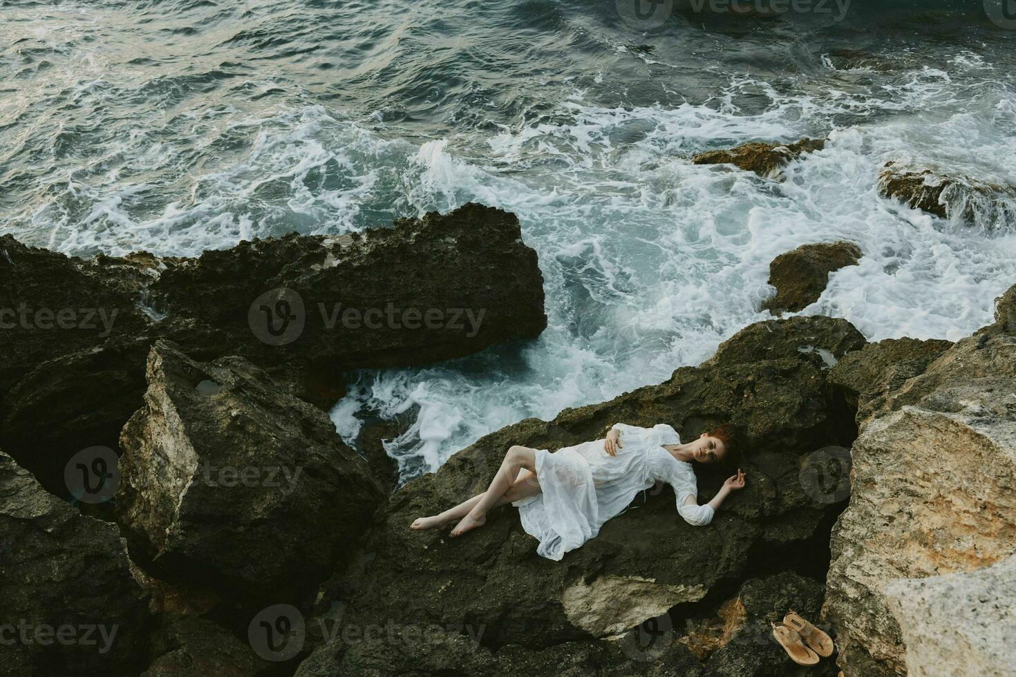 Beautiful bride in white wedding dress on sea shore wet hair vacation concept photo