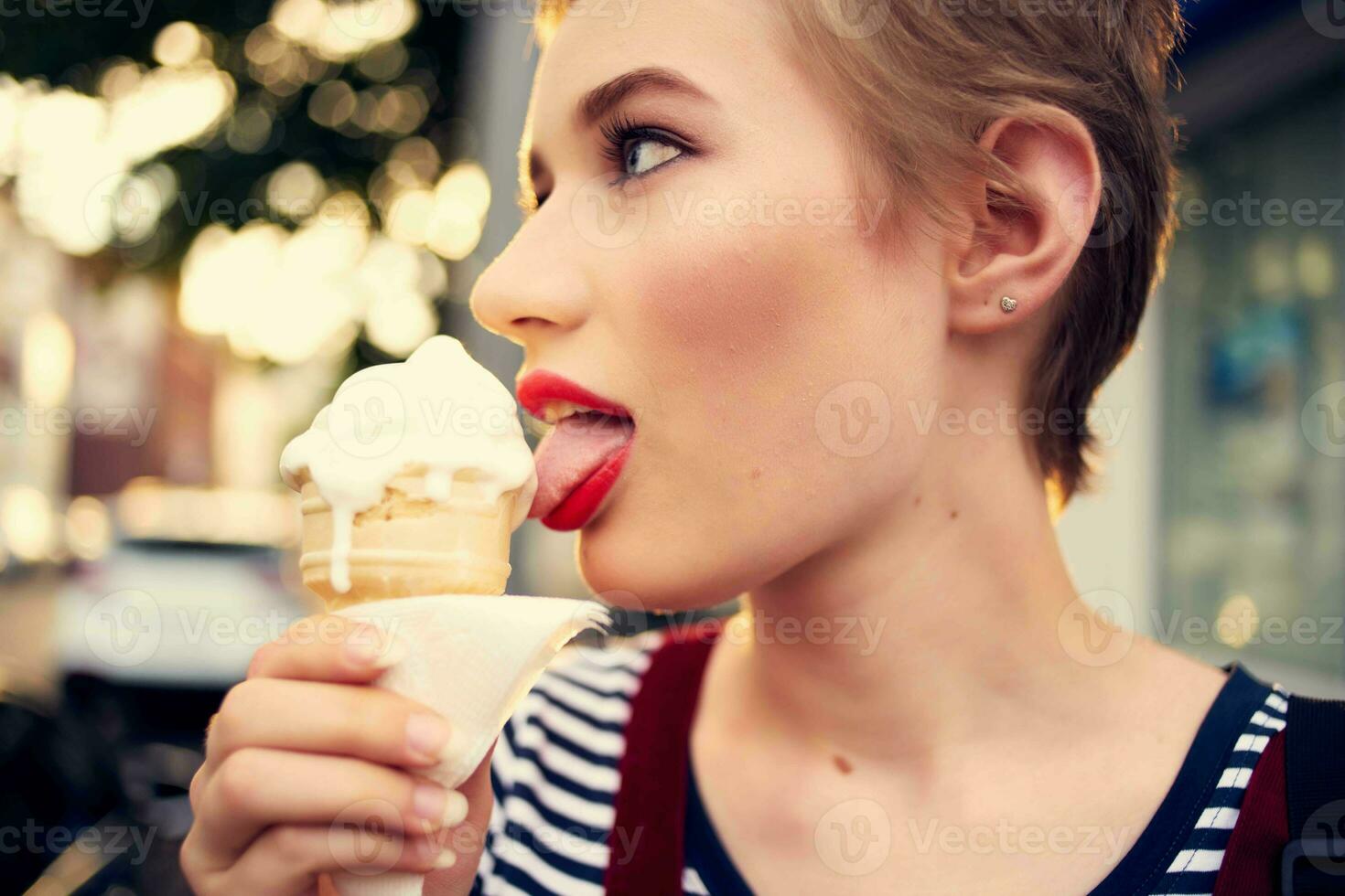 short haired woman outdoors eating ice cream walk lifestyle photo