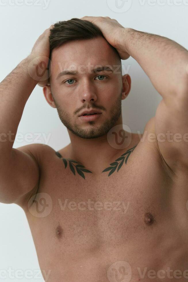 Sporty Sexy Muscular Handsome Naked Man holds hands on head posing isolated on over white studio background. Cool fashion offer. Model shoot for ad. Copy space photo