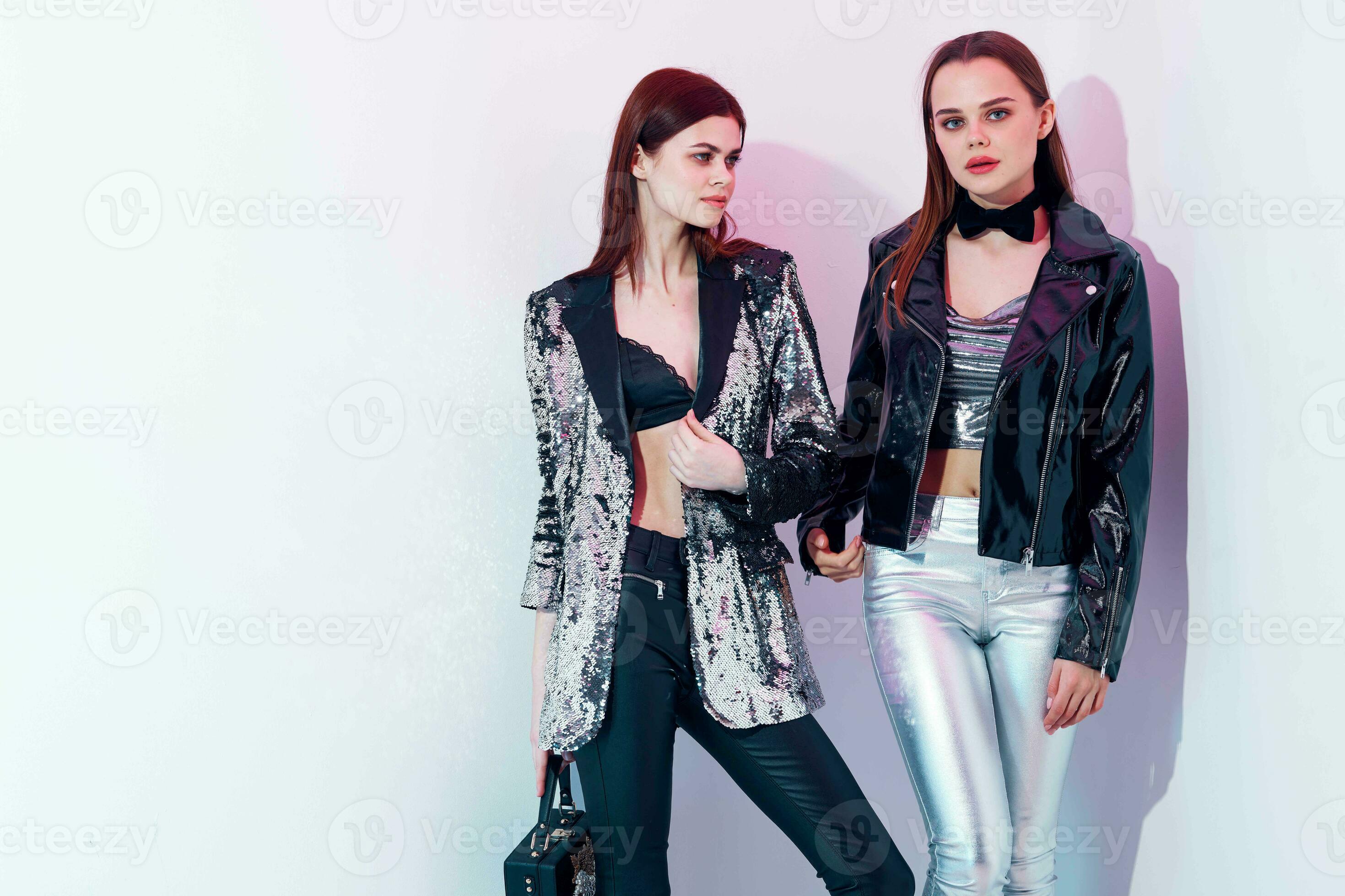 two trendy women in modern style disco clothing 23692334 Stock Photo at  Vecteezy