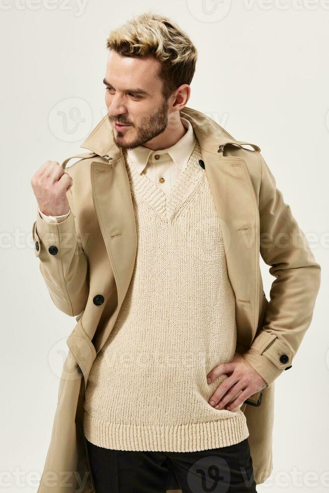 man gesturing with hand beige coat modern style cropped view photo
