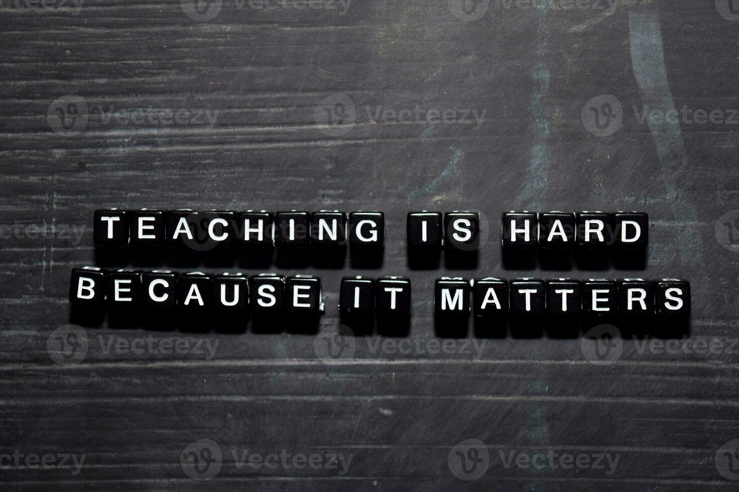 Teaching is hard because it matters on wooden blocks. Education, Motivation and inspiration concept photo