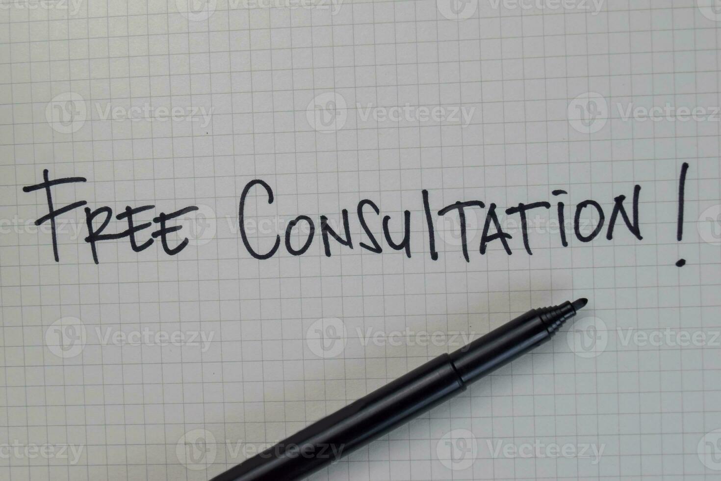 Free Consultation write on a book isolated on Wooden Table. photo