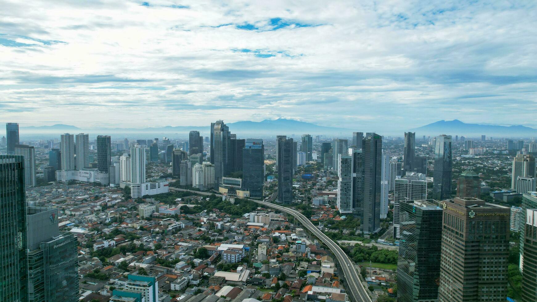 Aerial view of quiet traffic on Sudirman street with skyscrapers during weekend in Jakarta city. Jakarta, Indonesia, March 8, 2022 photo