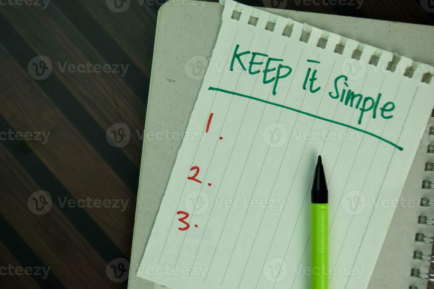 Keep it Simple write on sticky notes isolated on Wooden Table. photo