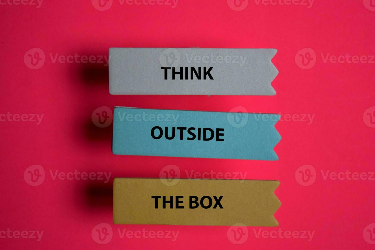 Think Outside The Box write on a sticky note isolated on Office Desk. photo