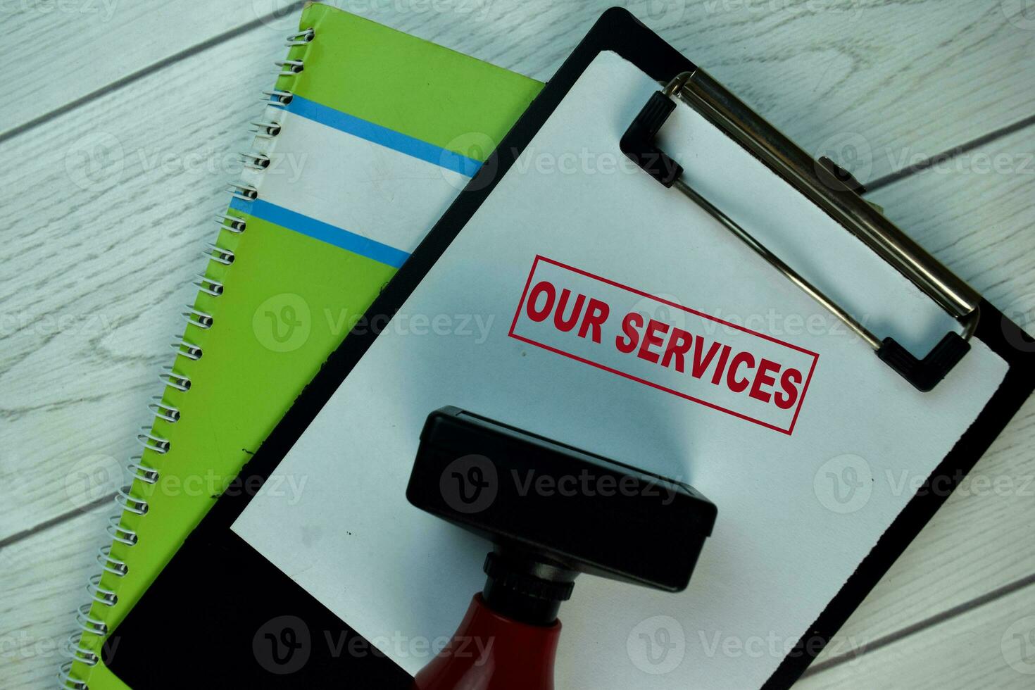 Red Handle Rubber Stamper and Our Services text isolated on the table. photo