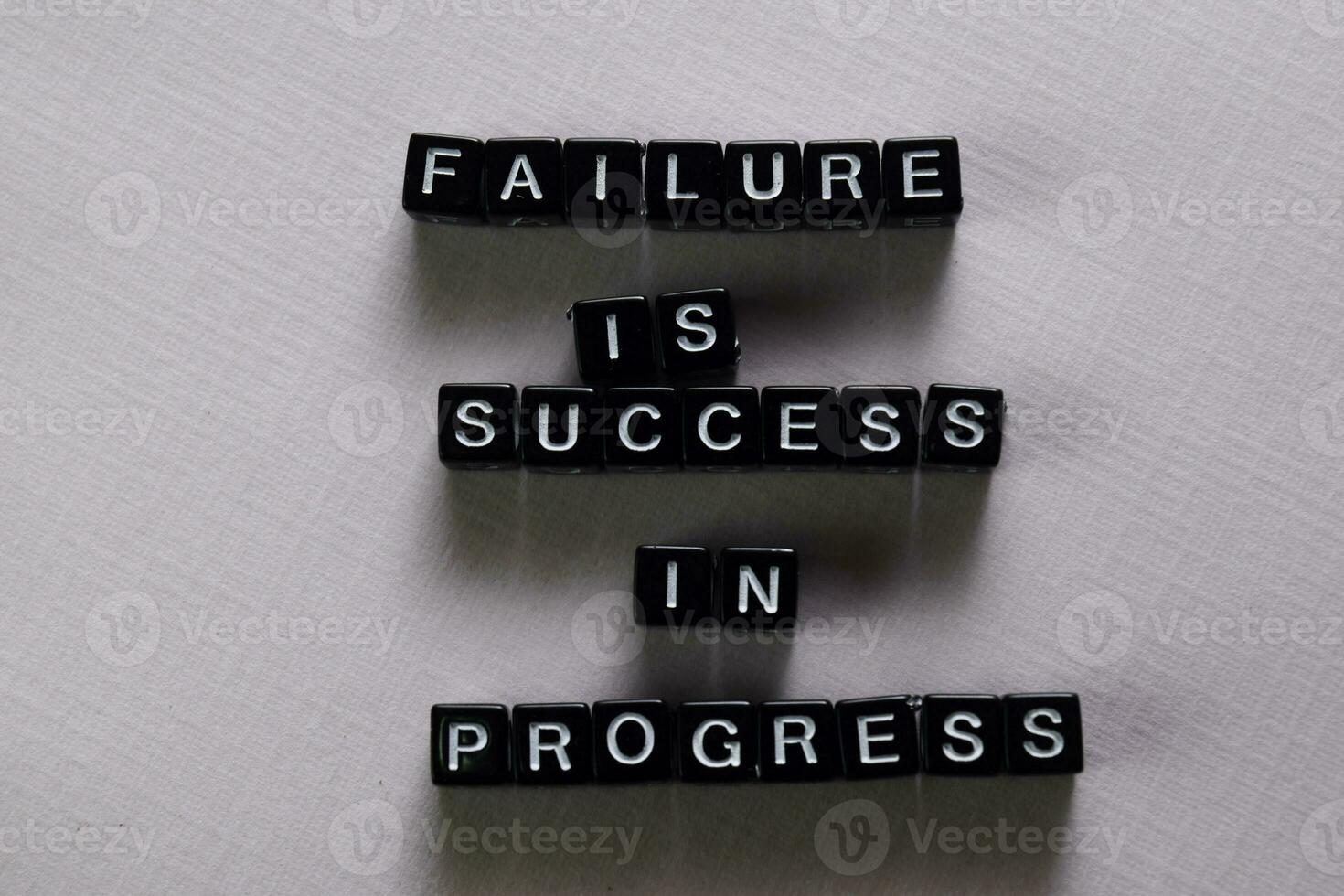 Failure is success in progress on wooden blocks. Motivation and inspiration concept photo