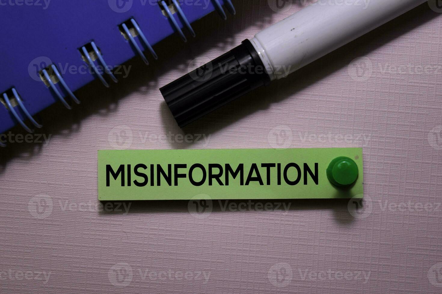 Misinformation text on sticky notes isolated on office desk photo