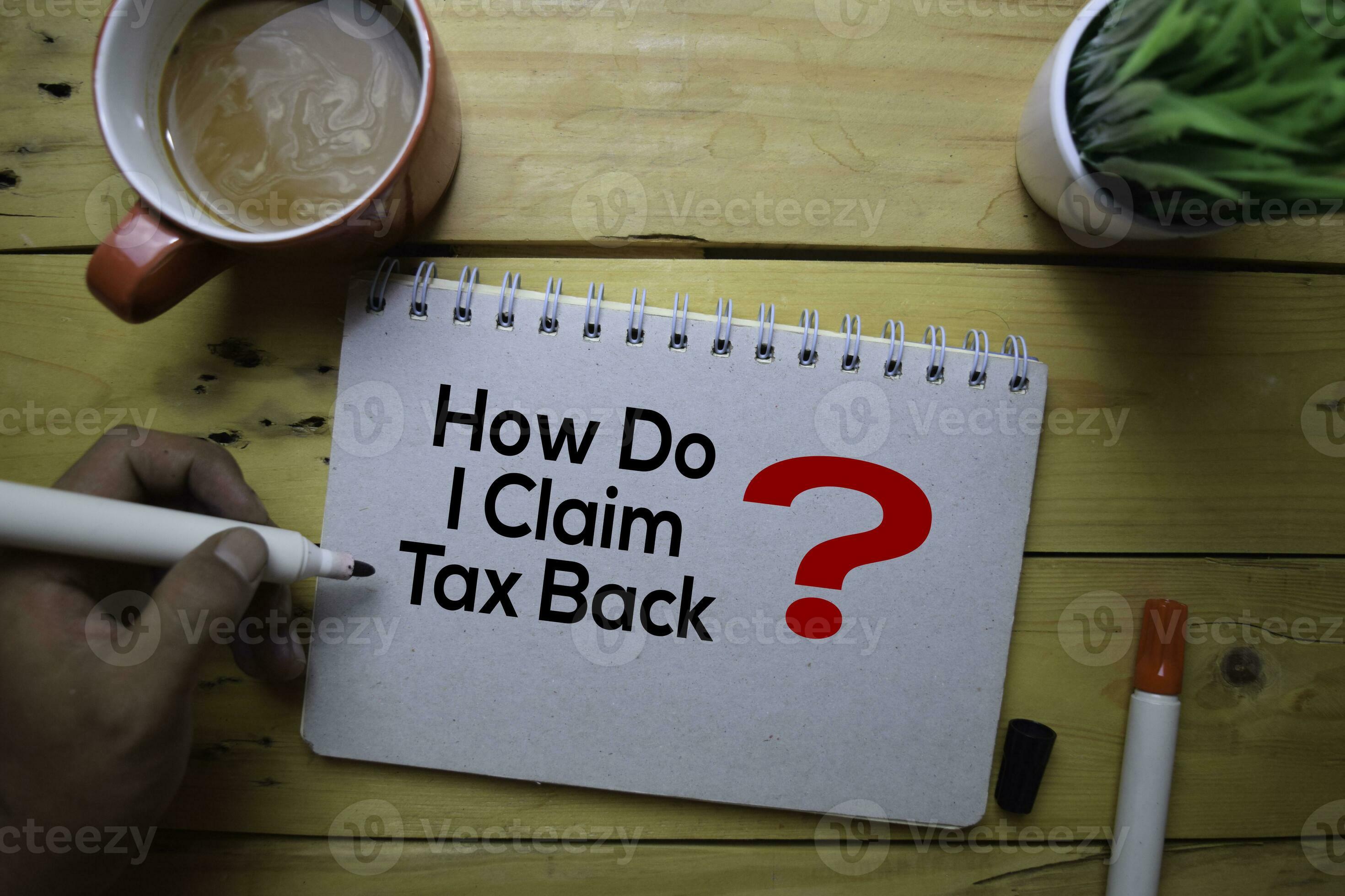 How Do I Claim Tax Back write on the book with wooden table background 23694963 Stock Photo at