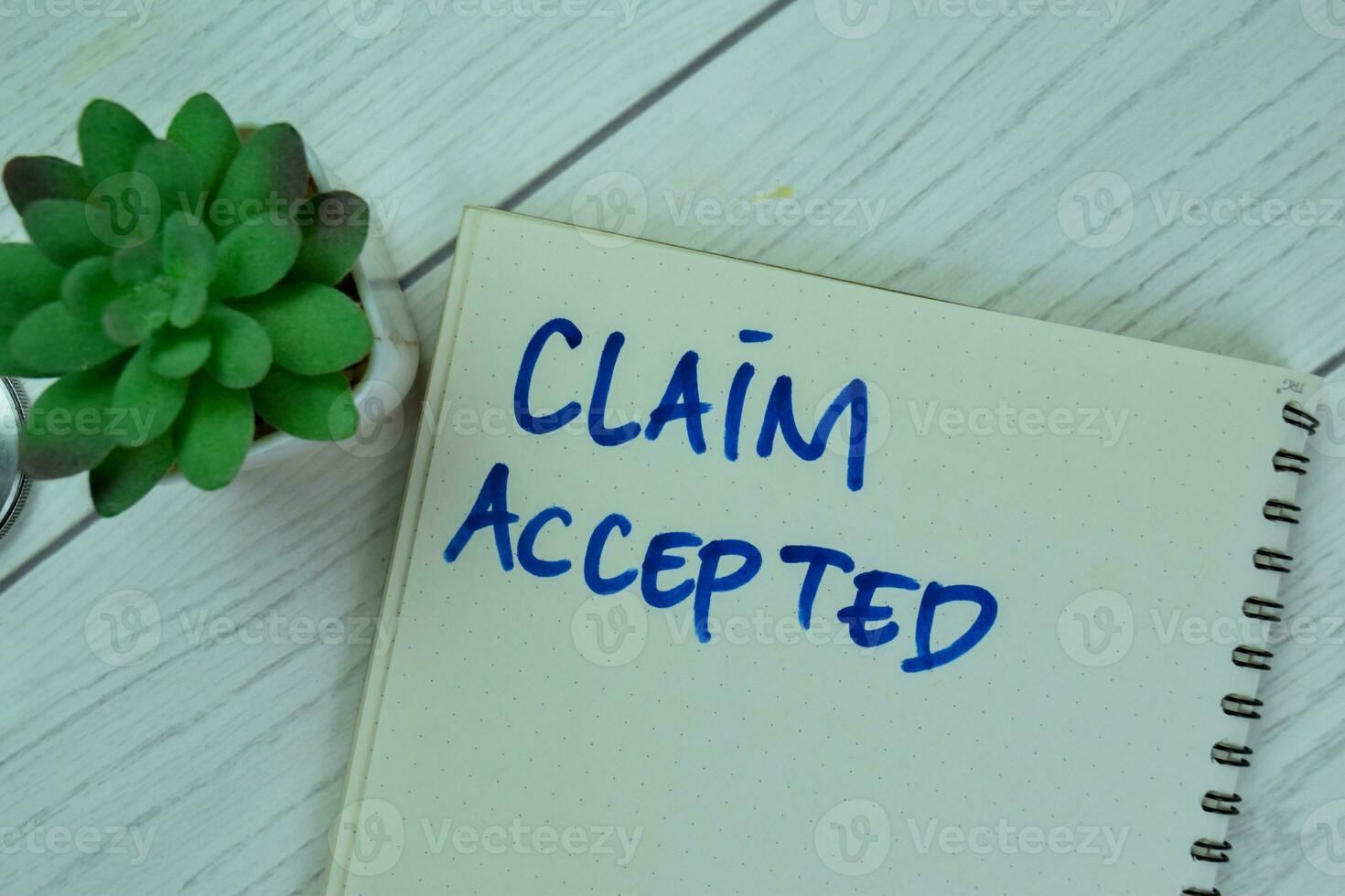 Concept of Claim Accepted write on a book isolated on Wooden Table. photo