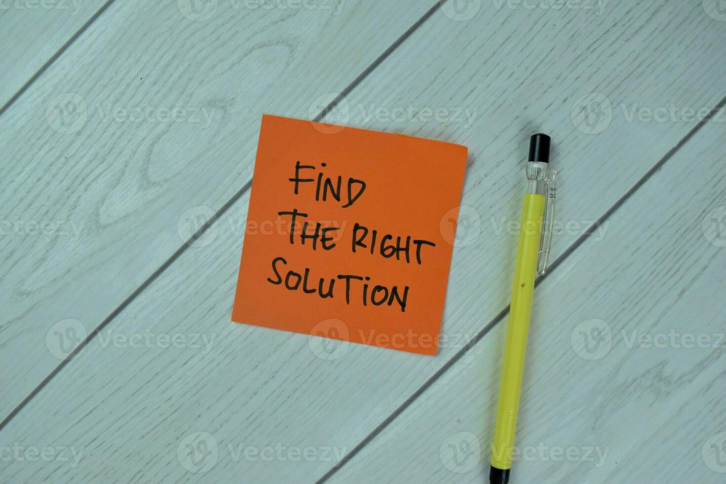 Concept of Find the Right Solution write on sticky notes isolated on Wooden Table. photo