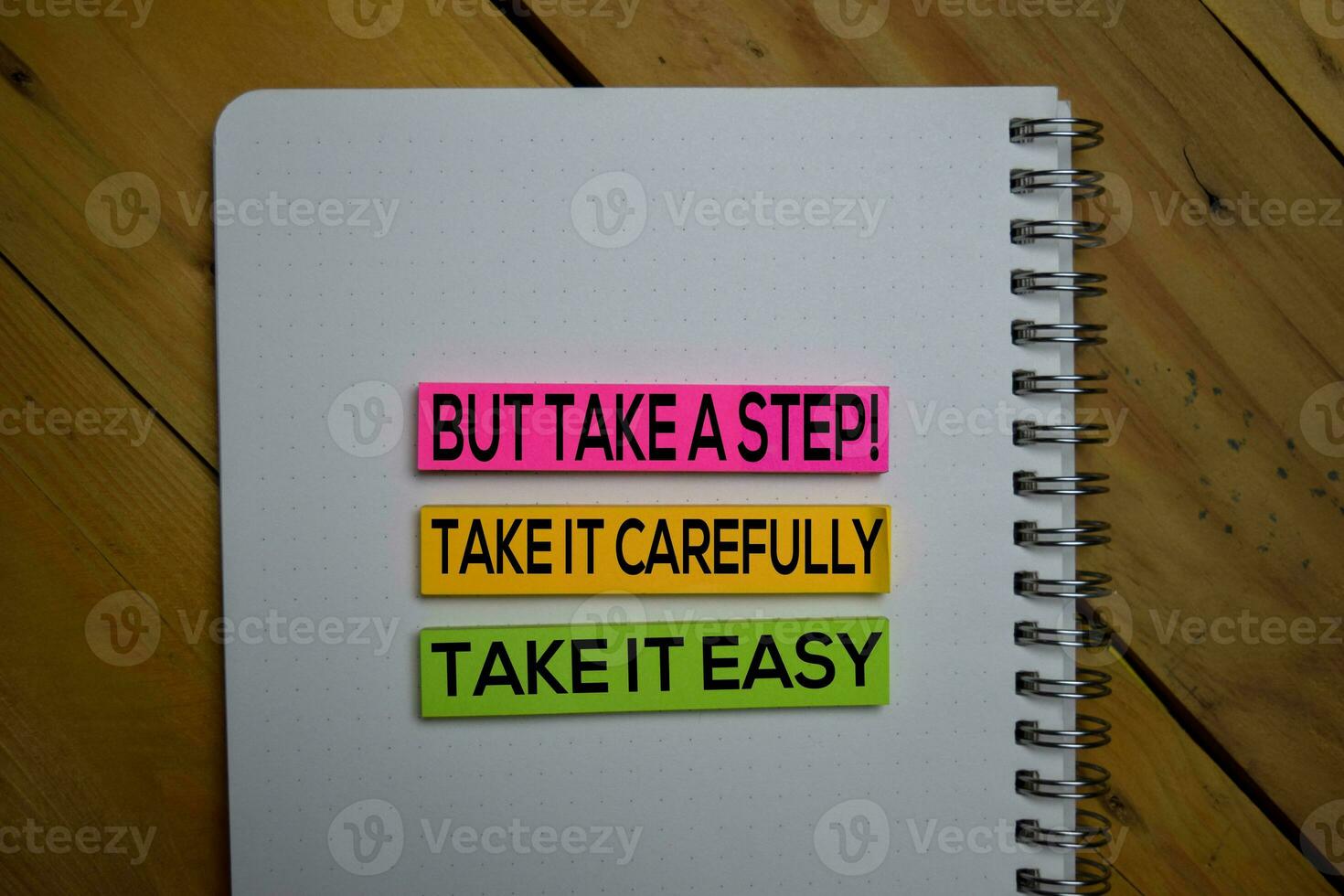 Take it East, Take it Carefully But Take a Step write on a sticky note isolated on wooden background. photo