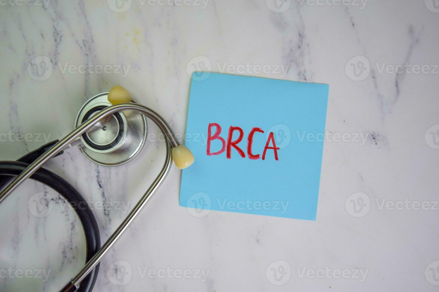 BRCA write on sticky notes isolated on Wooden Table. photo