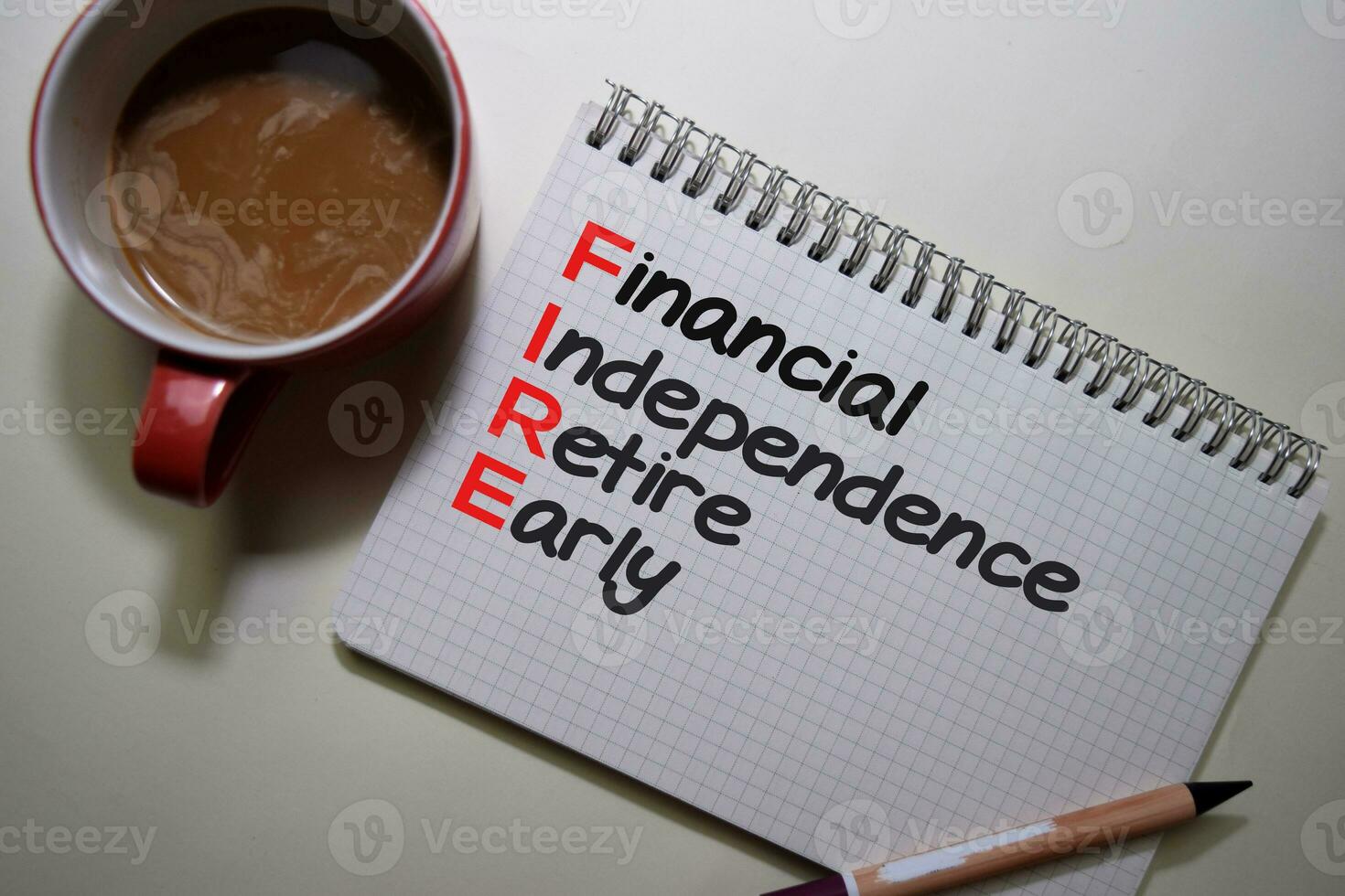 Financial Indipendence Retire Early write on a book isolated on Office Desk. photo