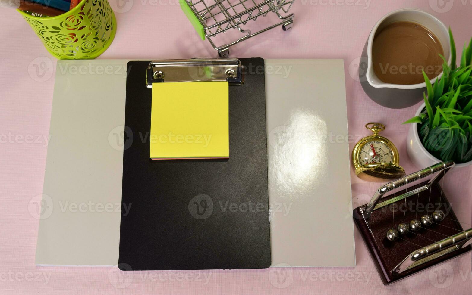 Top view of the notepad and clipboard with a marker drawing on a pink table, preparing to do homework. Drawing Working Desk Concept. photo