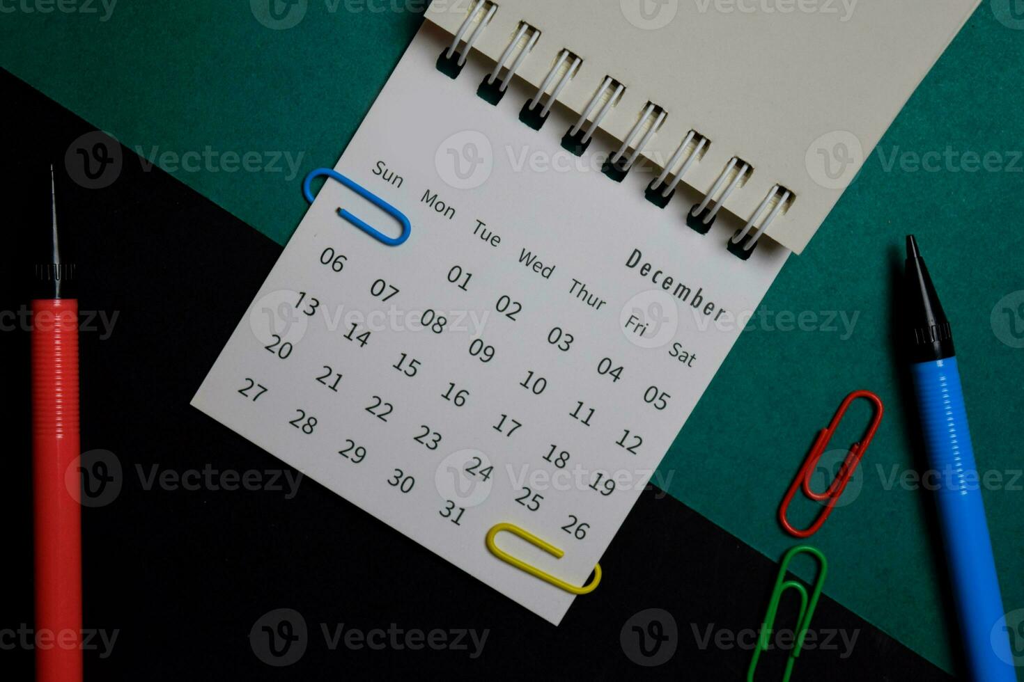 Top view December monthly Calendar isolated on office desk photo