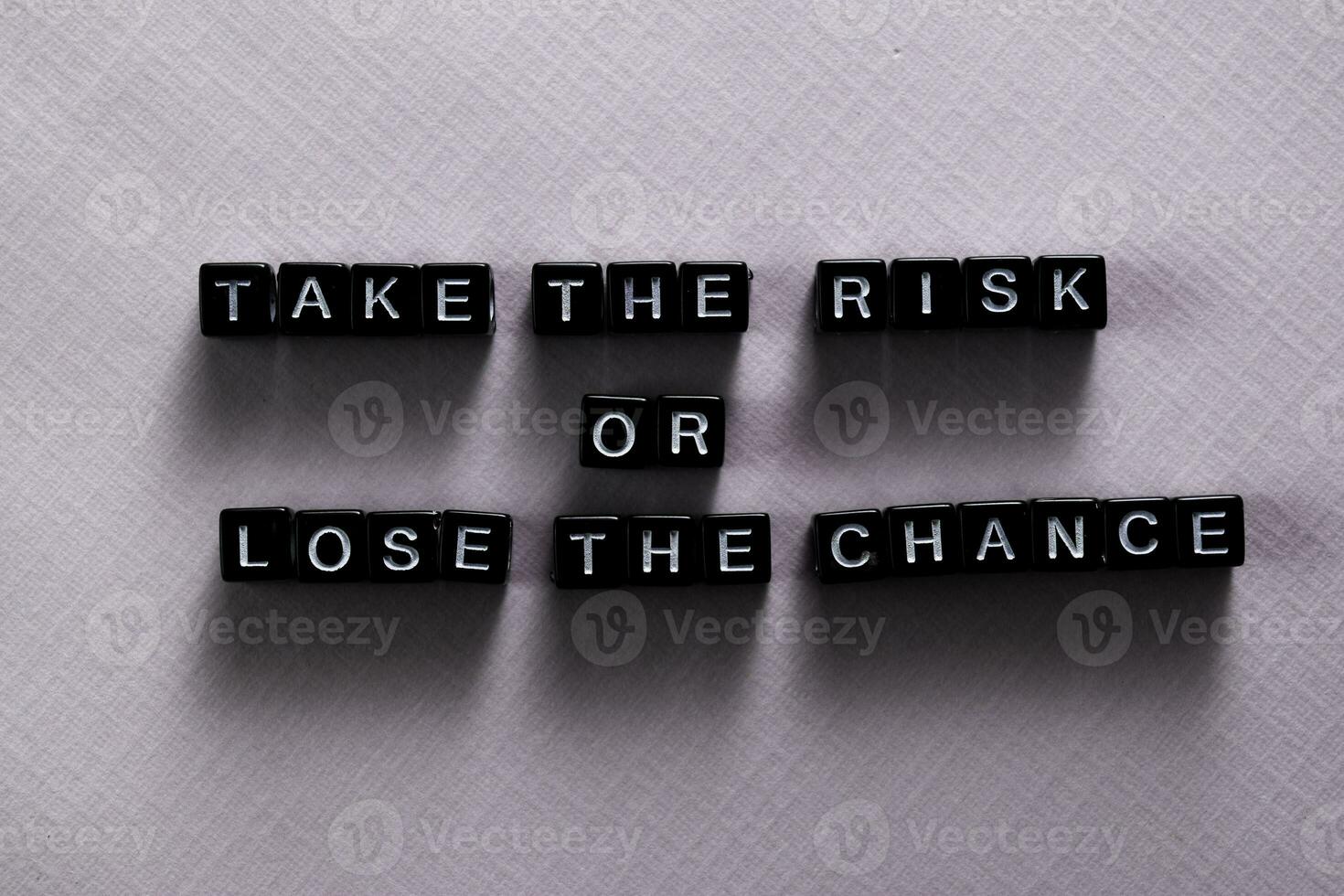 Take the risk or lose the chance on wooden blocks. Motivation and inspiration concept photo