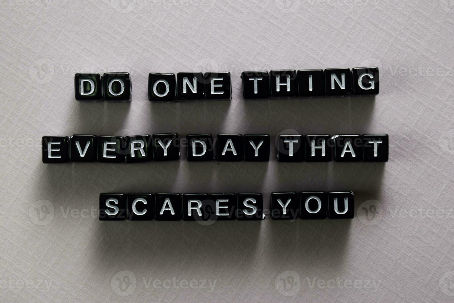 Do one thing everyday that scares you on wooden blocks. Motivation and inspiration concept photo